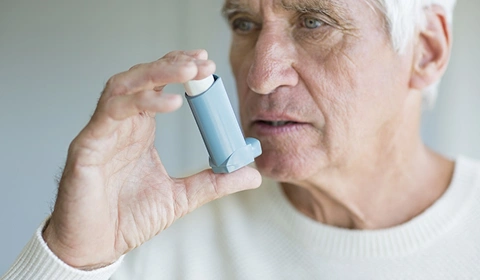 Man holding inhaler